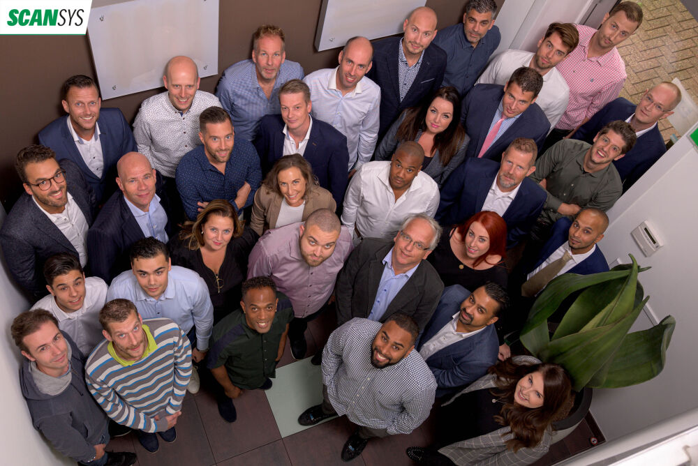 Het team van Scan Sys kijkt naar boven met blije gezichten dankzij Advisie Solutions
